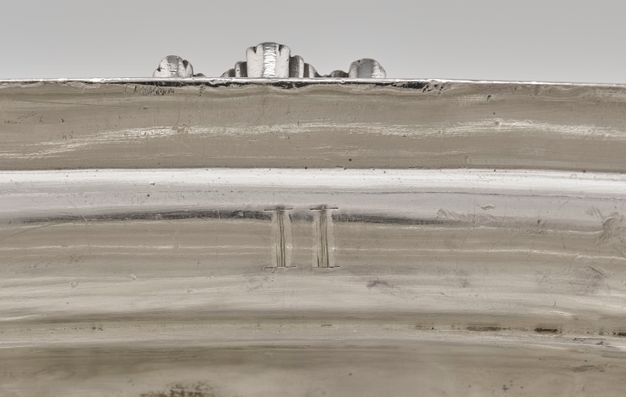 Close-up of the Roman number II on the interior rim of the tureen.