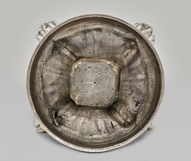 Circular base of the sugar caster with a square in the center with the caster's numeral and weight inscribed along its top edge.