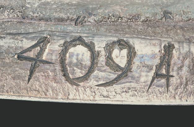 Close-up of the numbers and letters 409A scratched on the vessel.