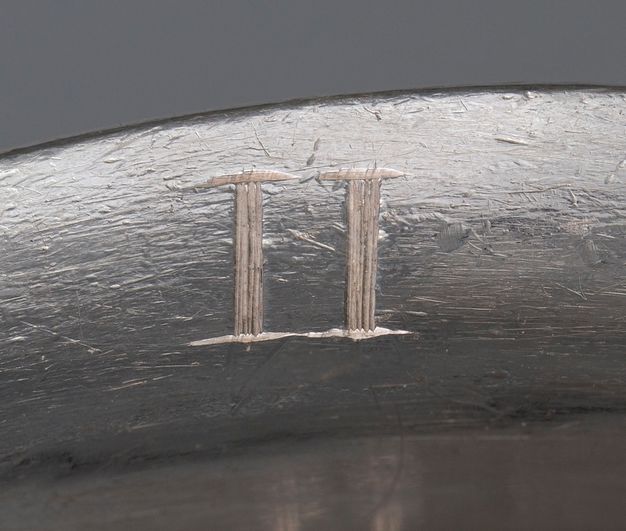 Close-up of the Roman numeral II scratched on the liner.