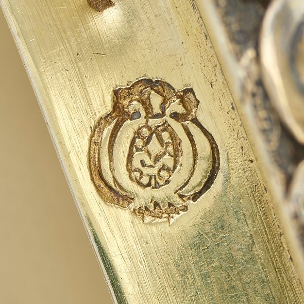 Close-up of a pomegranate stamped on the bowl's lid.