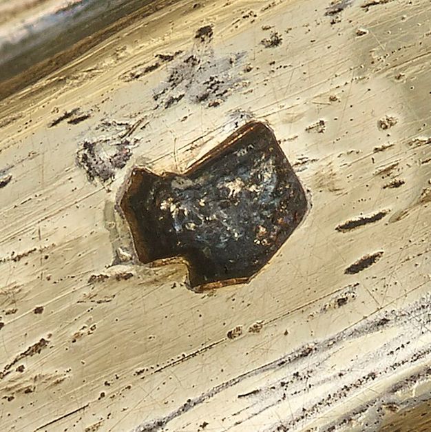 Close-up of a boar head stamped on the bowl's lid.