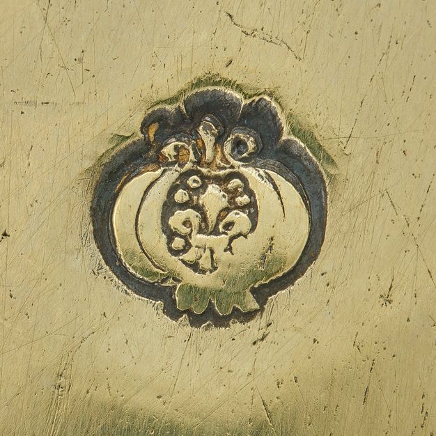 Close-up of a pomegranate stamped on the bowl's exterior.
