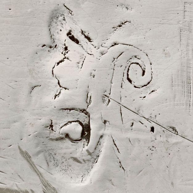 Close-up of an A with a crown at its side stamped on the stand.