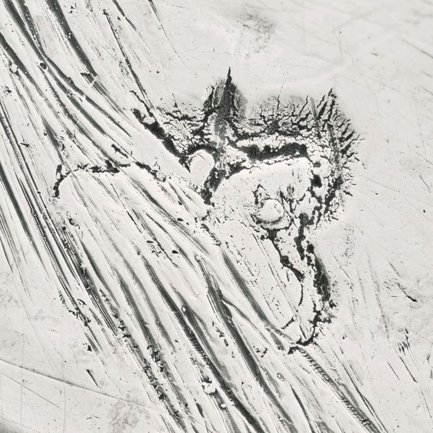 Close-up a scratched out symbol stamped on the stand.