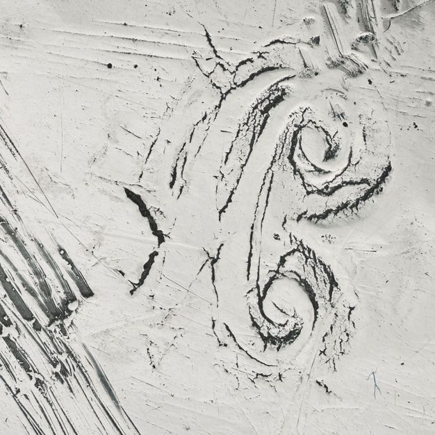 Close-up of a partially stamped A with a crown on its side.