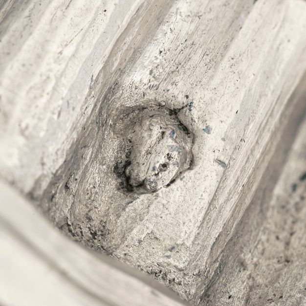 Close-up of a partially stamped human foot on the vessel.