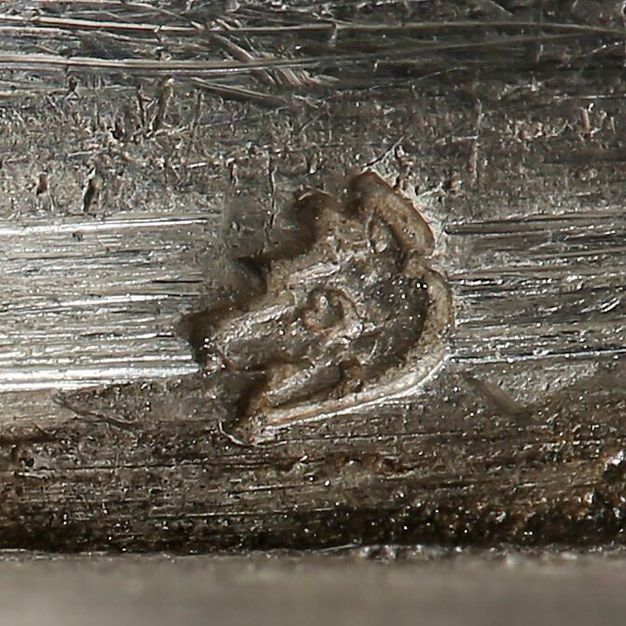 Close-up of a fox head stamped on the vessel.