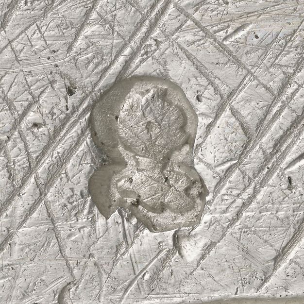 Close-up of a helmet and open visor stamped on the lid.