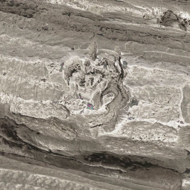 Close-up of a partially stamped human foot on the vessel.