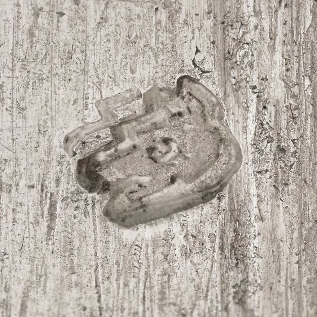 Close-up of a fox head stamped on the vessel.