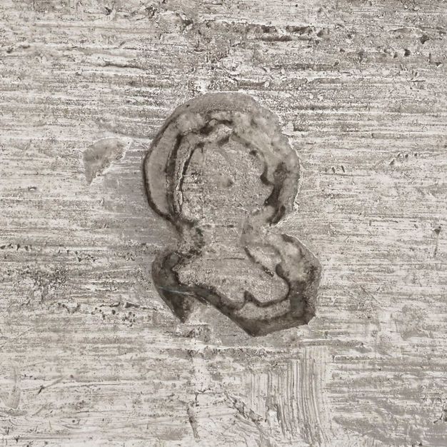 Close-up of a helmet and open visor stamped on the vessel.