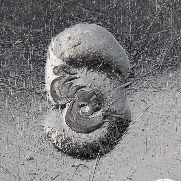 Close-up of a partially stamped crowned A on the liner.