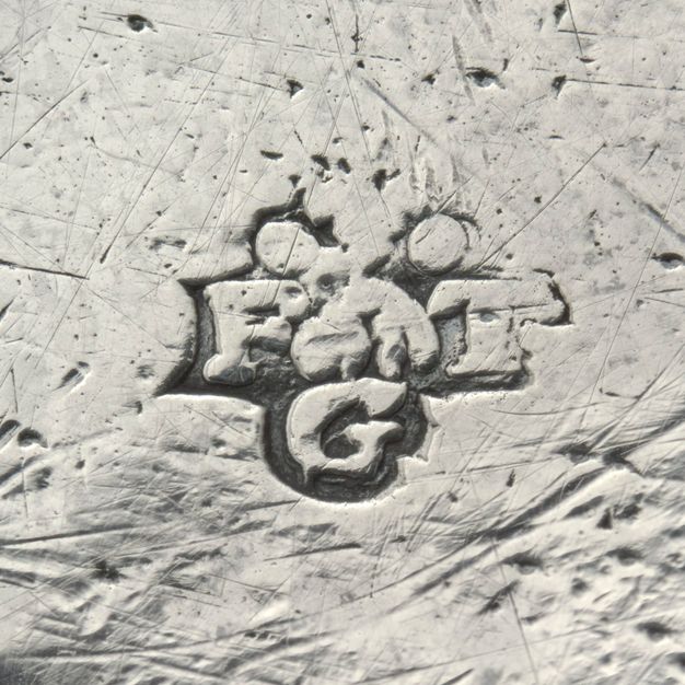 Close-up of the letters FTG stamped on the tray.