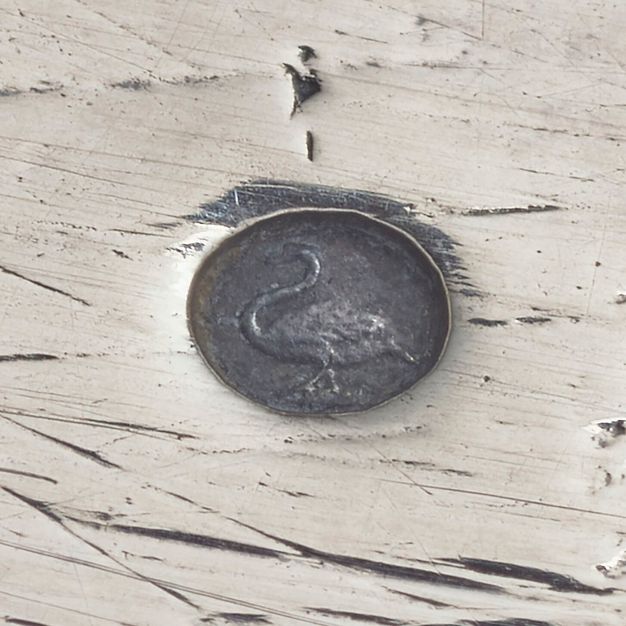 Close-up of a swan in an oval attached to the tray.