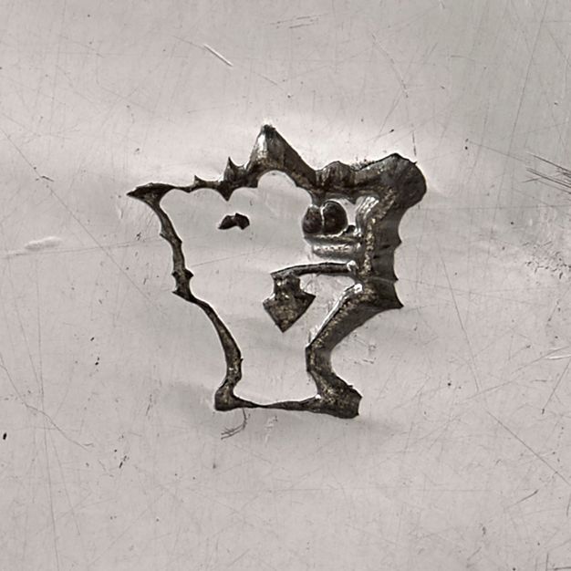 Close-up of a faded crowned Y stamped on the sauceboat.