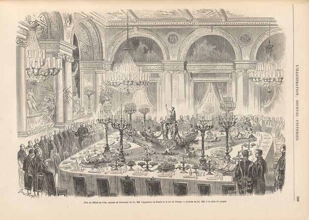 Black-and-white illustration from an engraving showing a grand room with a large table set for dinner, with sculptures and candelabras at the center. The table is surrounded by standing figures.