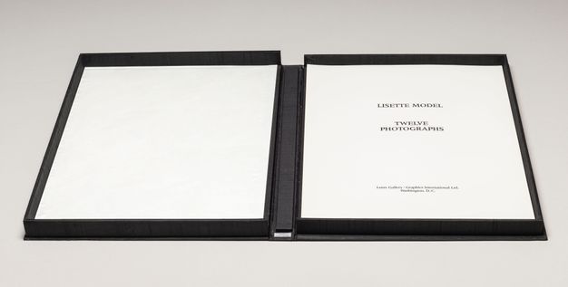 A display box shown open on a flat surface. Inside, the title page is printed in black type on white paper.