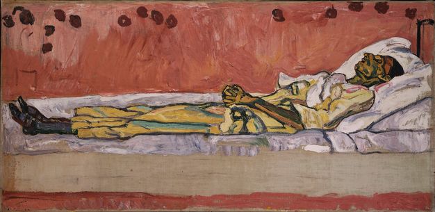 A painting of an emaciated woman lying on a white mattress, her back propped up on pillows. The area around the bed is painted a rusty shade of red in bold brushstrokes. Along the upper edge of the picture, dark red spots resembling roses cluster in groups, as if to suggest a wallpaper pattern.