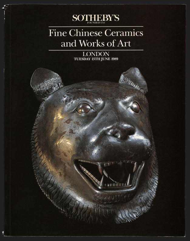 A black book cover with the name “Sotheby’s” and the title, date, and place of the sale in white text at the top. The bottom two-thirds of the cover features a photograph of a bronze tiger head turned slightly to its left.