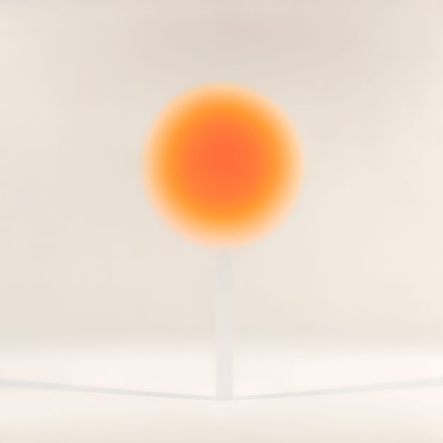 A luminous orange disc, darker and vibrant at its center, fades gradually to yellow at barely perceptible edges. Its thin, translucent base casts a shadow to either side.