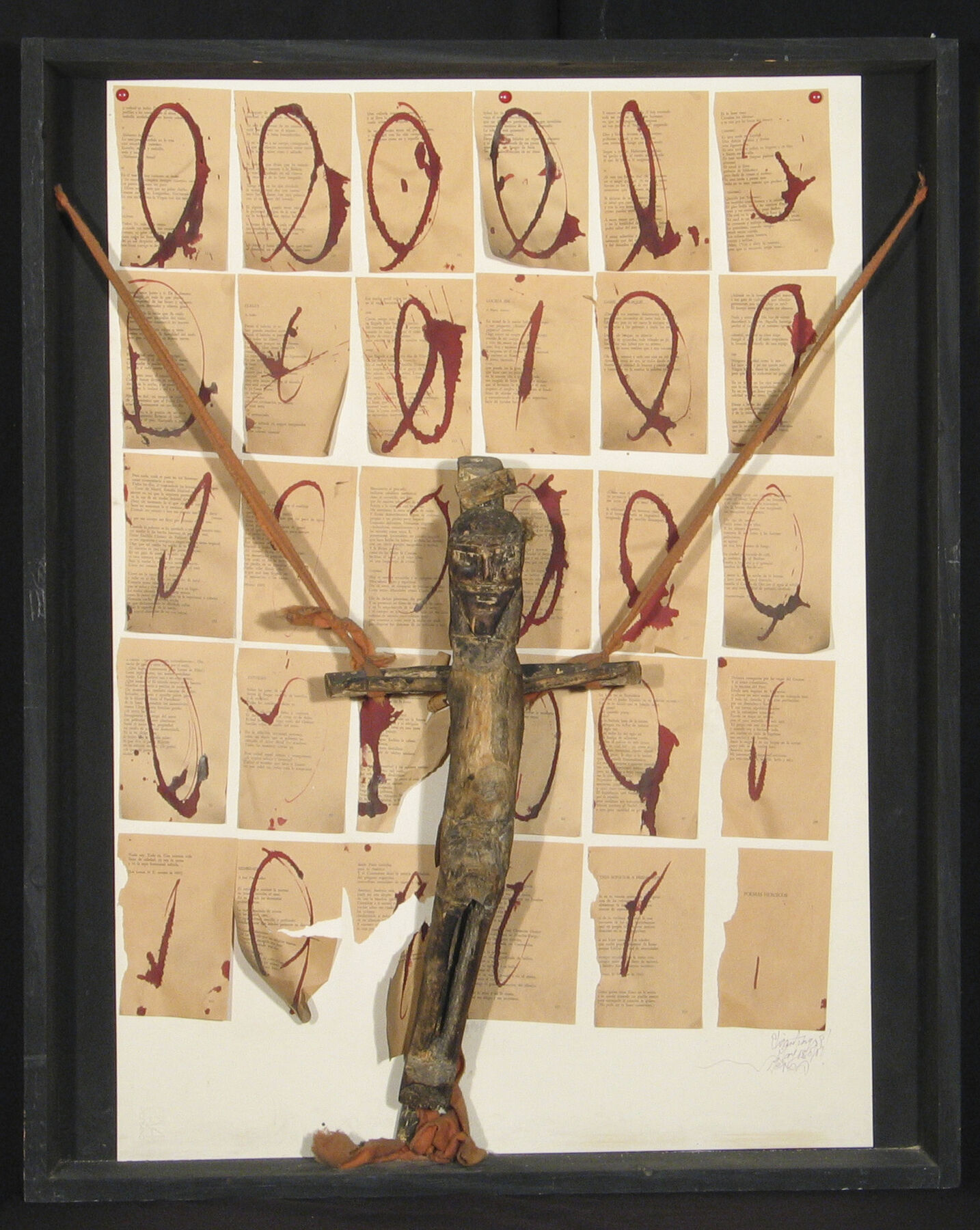 A wooden figure resembling the crucifixion ontop of circular blood stained pages
