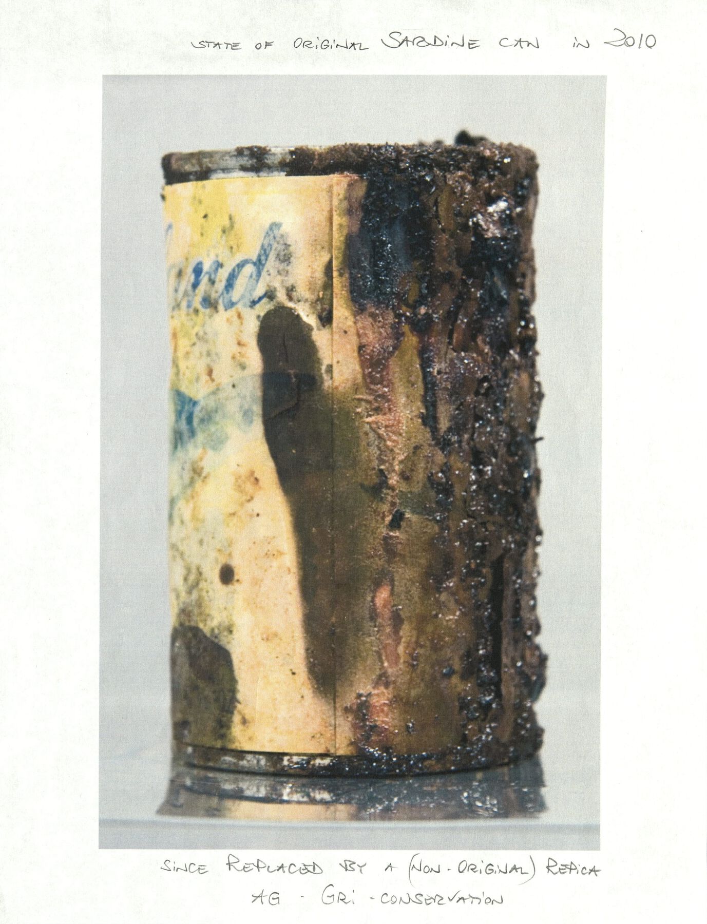 A yellow sardine can, with soggy deteriorating mold coming from its right side