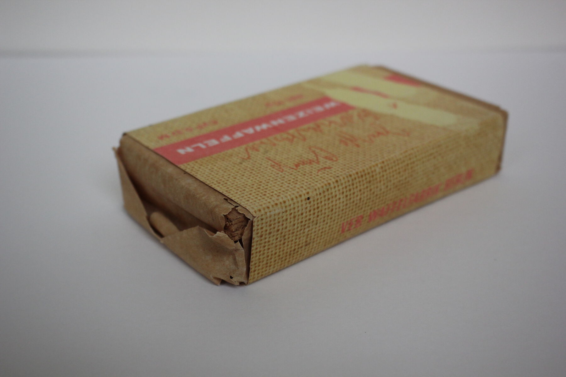 Overhead view of package with tearing paper extruding as it fades into the background