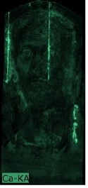 A black image with very light shading in different tones of green that enables the identification of a human face.