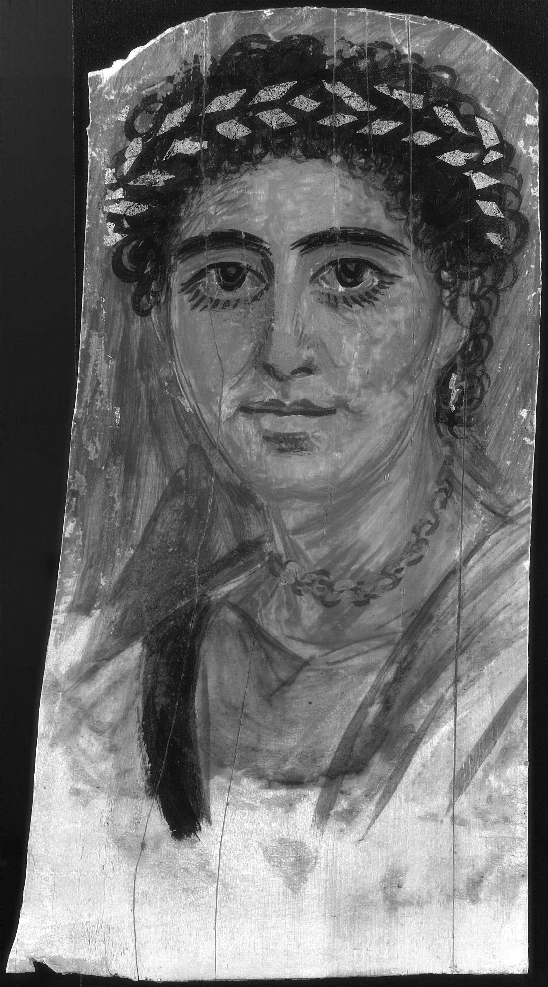 Grayscale image of a portrait of a woman with curly hair and prominent dark eyebrows wearing a wreath-like headpiece and jewelry.