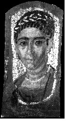 Grayscale image of a portrait of a woman with textured hair pulled back and prominent dark eyebrows. She wears a wreath-like headpiece. Areas around her forehead, cheeks, and mouth appear in a lighter color. The area around and behind her appears in bright white. Similarly bright lines can be seen around her neck and chest.