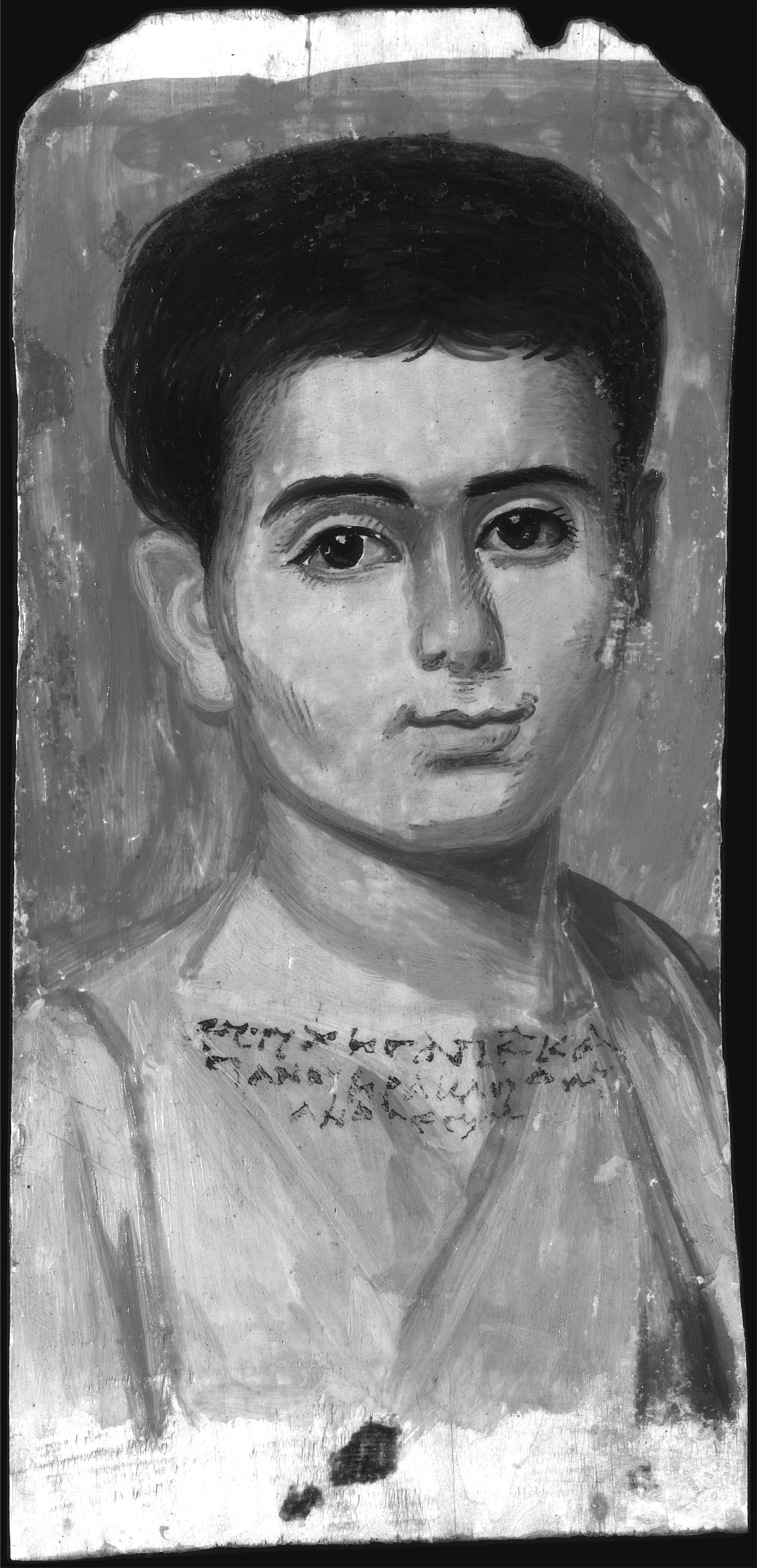 Grayscale image of a portrait of a young person with short dark hair and smooth features, wearing a light garment with inscriptions or decorative motifs visible across the chest area.