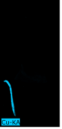 The image is completely dark except for a bright blue line on the bottom left corner that indicates the presence of copper in the right vertical stripe on the individual's tunic.