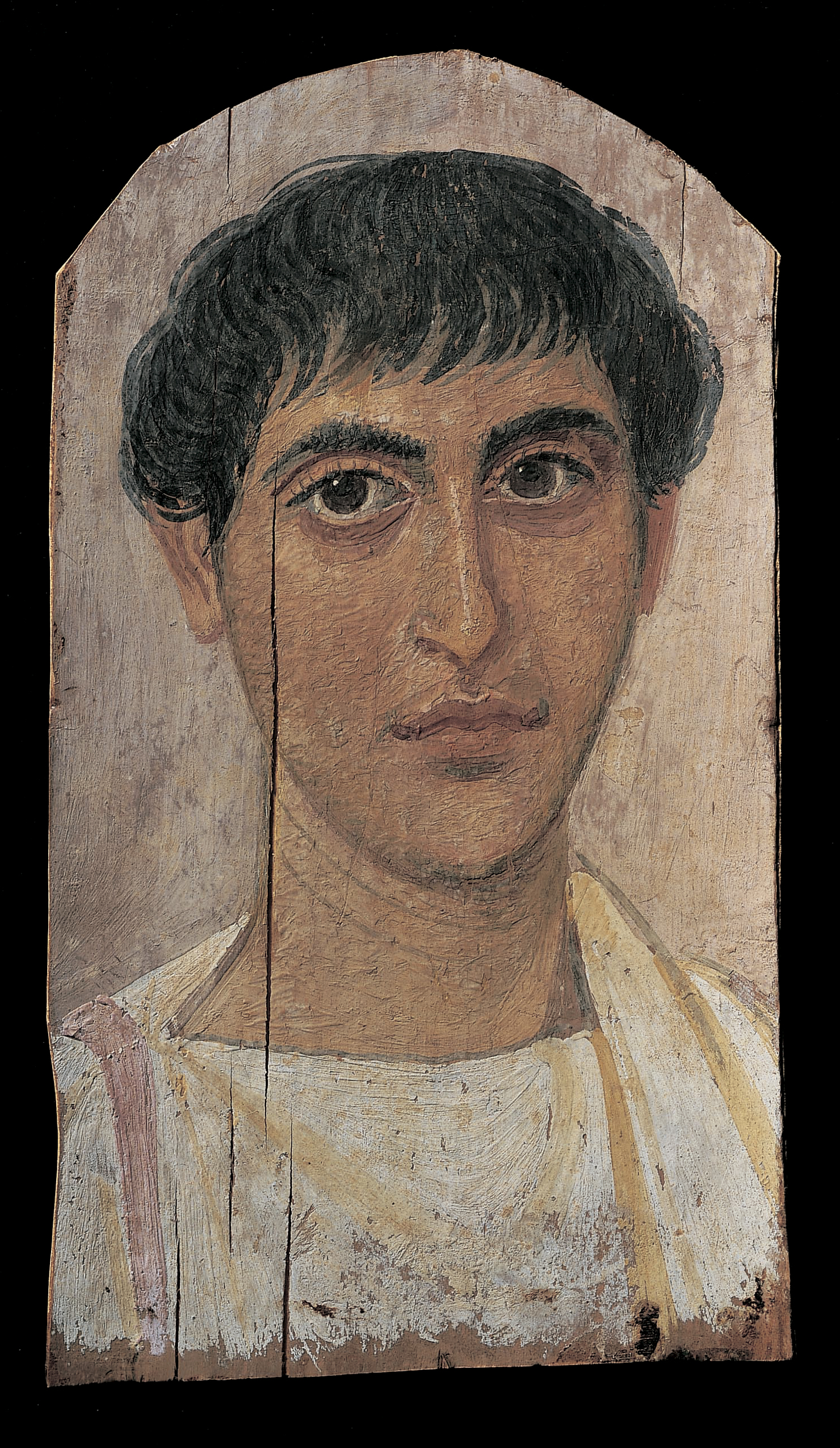 Portrait of a man with an oval face and dark hair and eyes. He wears a white tunic. A prominent vertical crack can be seen on the paint to the left of the man's eye.