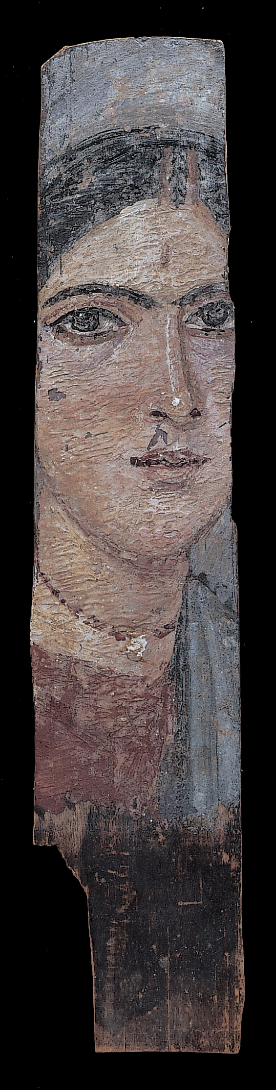  Partial portrait of a woman. Only the central area has been preserved leaving the woman's right ear and left section of her face missing. She has dark hair, eyebrows, and eyes. Her eyes appear to be delineated in black. She wears a blue and red tunic, as well as a beaded necklace with a central, bright pendant. There are small losses to the paint below the woman's nose and on her upper left cheek. The bottom section of the portrait is unpainted.