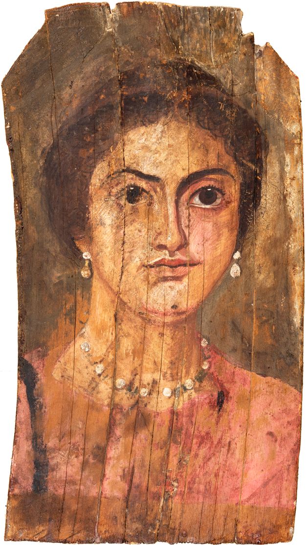 Portrait of a young lady wearing a pink tunic, a gold pearl necklace with green stones, and pearl earrings. Her hair is up.