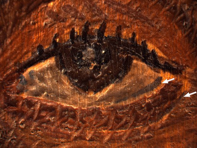 Close-up image of a painted eye from portrait E of an elderly lady. There are two white arrows at right: one points to the dark shade of the eye's water line, and the other points to the dark undereye. 