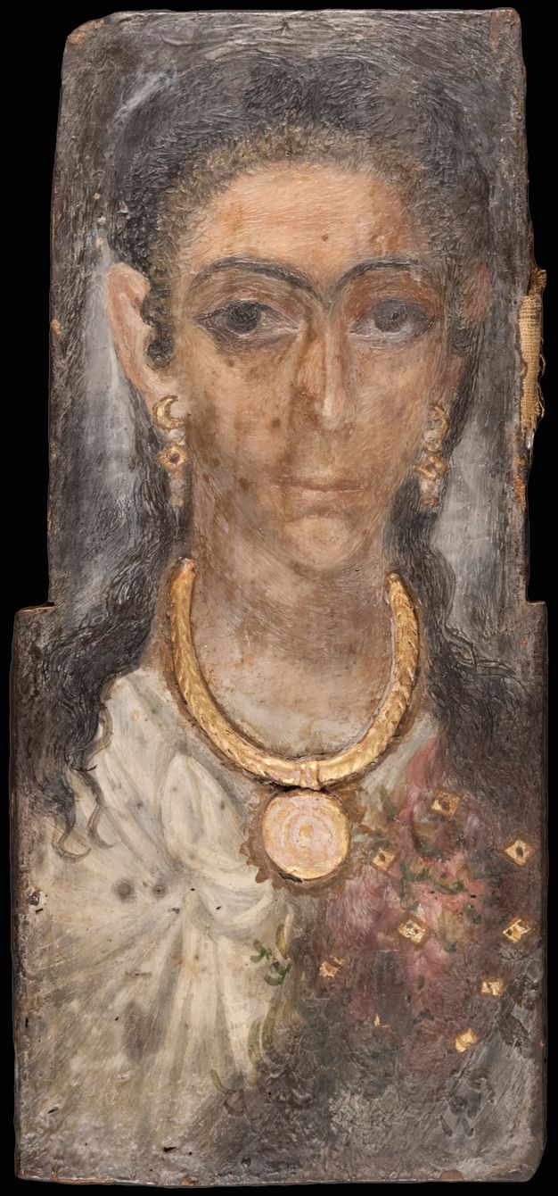 Portrait of a woman with a collar-like gold coin pendant necklace. Half her hair hangs down in curls around her shoulders. She wears dangling gold earrings with two white beads or pearls in each. Her garment is white with a dark purple detail coming down and across her chest from the proper left shoulder. There are golden squares in the purple garment. The paint is faded.