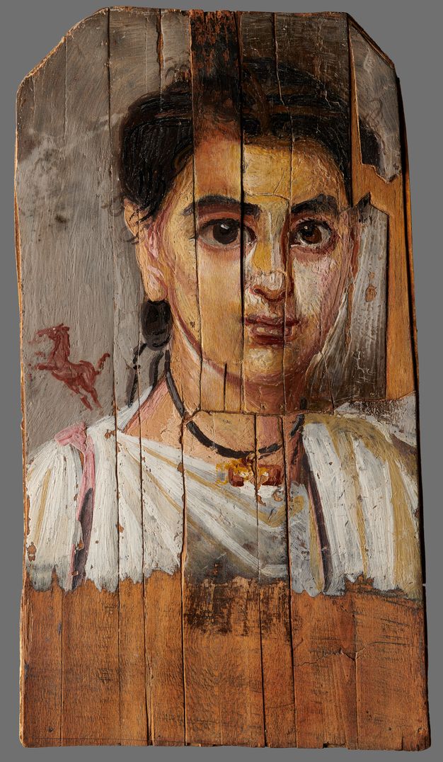 Portrait of a child with soft facial features, dark hair cinched behind the right ear, and dark eyes that look straight at the onlooker. The child wears a white tunic and a necklace with a tubular, golden pendant. A small rearing horse appears above the child's right shoulder; it has been painted in pink-reddish tones. The lower section of the panel is unpainted, revealing the brown color of the wood exposed.