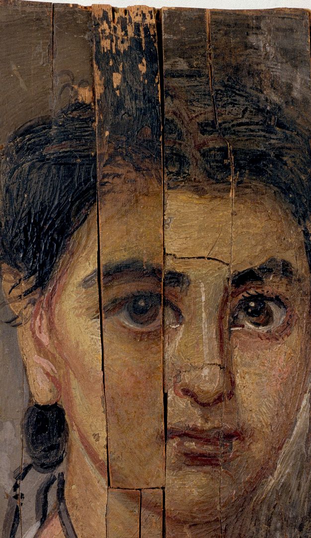 Detail of the child's portrait showing a close up of the child's face. Missing paint can be appreciated at the top of the board that includes the child's right eye.
