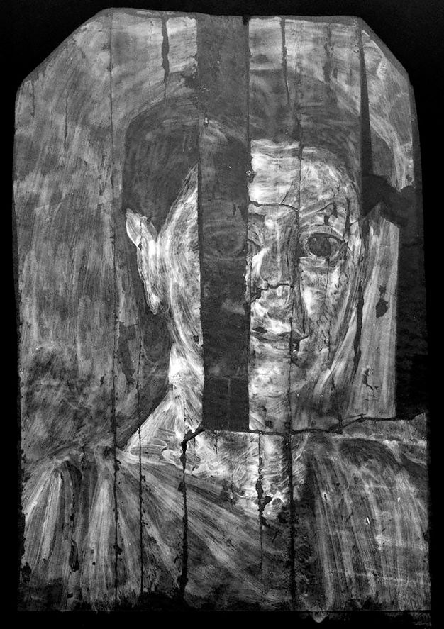 X-radiograph of a child's portrait. The image appears in black and white and the child's facial features are difficult to identity. The direction of the brushstrokes is apparent and a clear difference can be appreciated between the appearance of the paint applied to the transplanted board and the rest of the portrait.