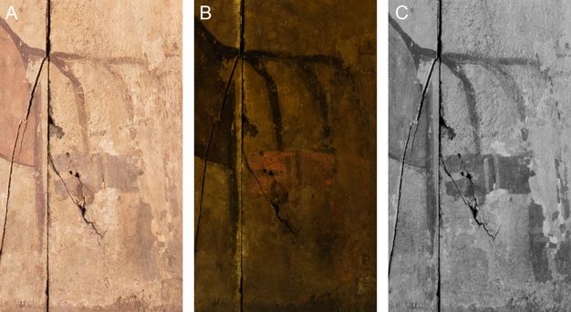 The image displays three views (A, B, C) of a painted wooden panel using multiband imaging techniques. Panel A shows the gammadion symbol in Visible Light. The symbol is painted with thin black lines on a light tan, cracked, and weathered surface. There are some faint reddish-brown areas visible beneath the black lines. Panel B shows the Ultraviolet-Induced Visible Fluorescence image. The background fluoresces a dark, brownish-yellow color, while the black lines of the gammadion remain dark and non-fluorescent. Panel C shows the Infrared Reflectography image. In this black and white view, the gammadion symbol is highly visible, appearing as dark black lines against a lighter grey background.