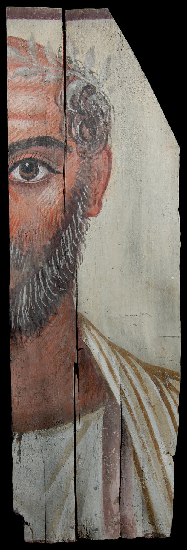 Partial portrait of an old man. Only half of the man's face and upper body is shown. His brown right eye is visible. He has grey hair and facial hair. On his head, he is wearing a wreath with white leaves that wraps towards his forehead. His garments are white in color, and his skin is tan. There is white detailing on his skin to show aging. 