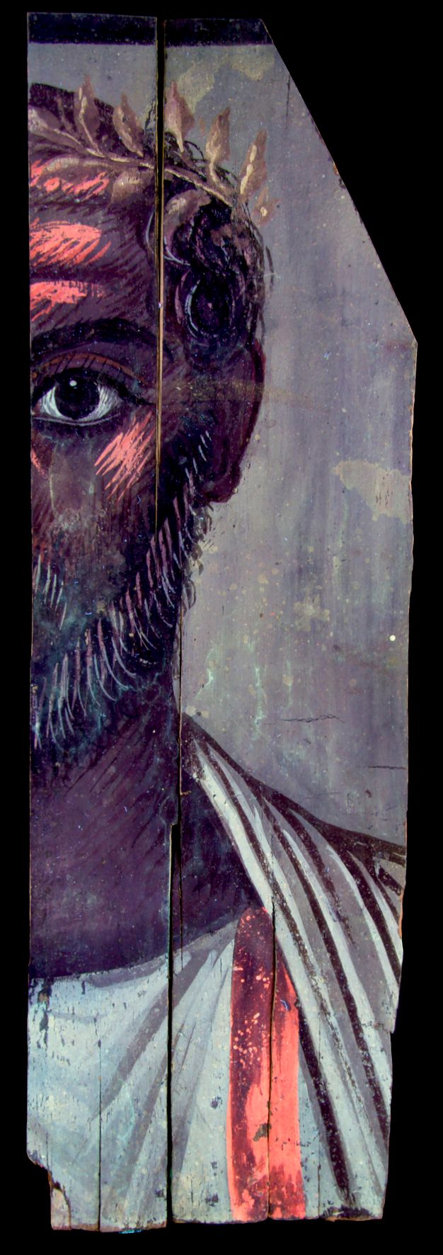 UVF image for figure 5.3. The man's skin, hair and facial hair appear darker. There is a bright pink hue shown on his forehead and cheek, where white detailing was previously shown, as well as on parts of his garment. The wreath detail is tan and gold in color. 