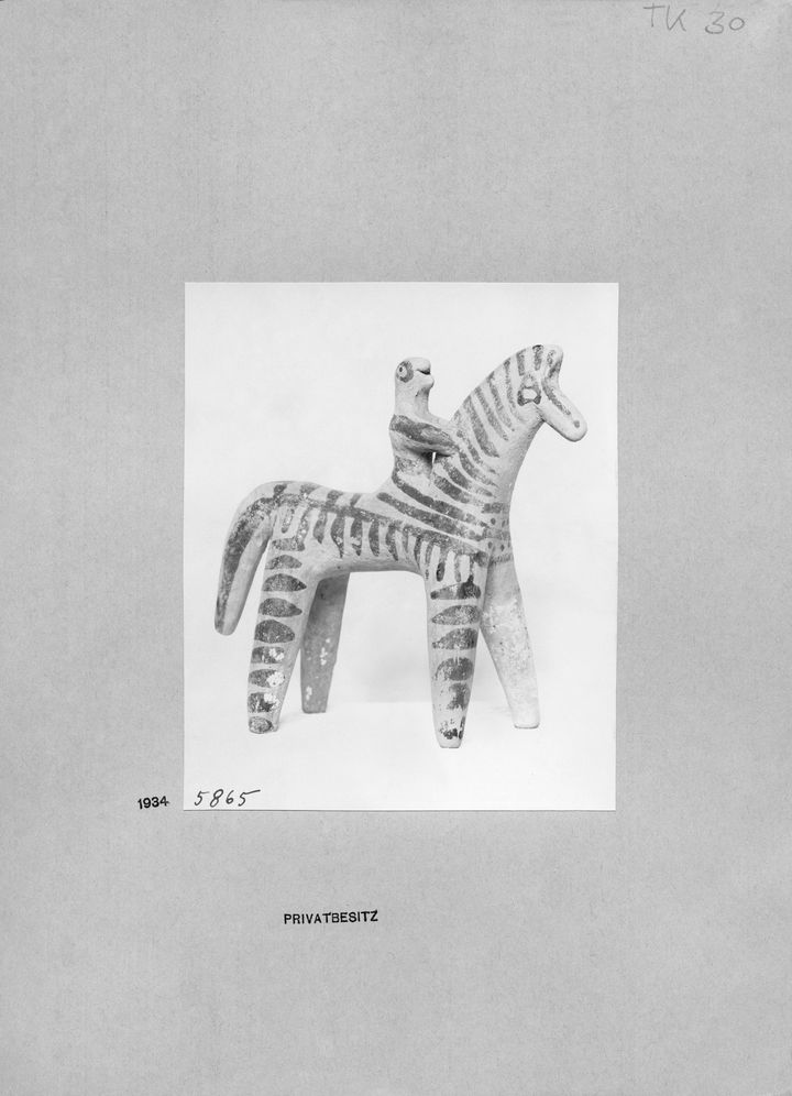 Scan of a black-and-white microfiche film showing the terracotta statuette shown in Figure 32. The number 5865 is written in the lower left corner of the image, and to its left, the number 1934 is printed. The phrase quote PRIVATBESITZ end quote appears below. A seal repeats faintly in the background of the film like a watermark.