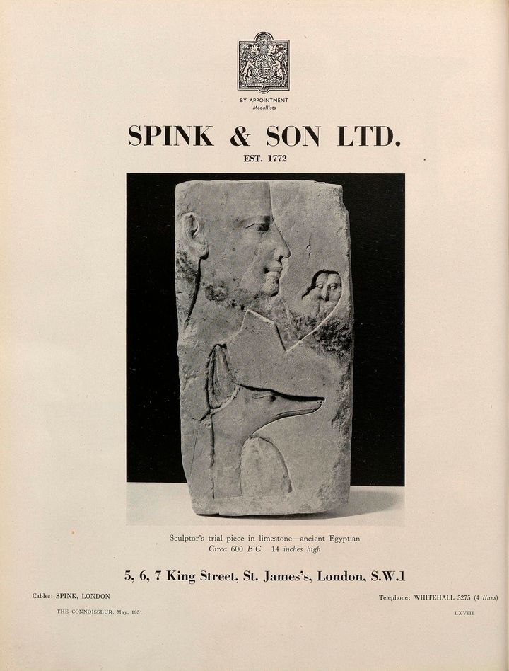 'Printed ad for Spink and Son Limited with a black-and-white reproduction of a shallowly carved panel showing a human face and a dog''s head in profile to the right as well as a bird looking forward. The caption below the image on the ad reads, quote Sculptor’s trial piece in limestone, ancient Egyptian, Circa 600 Before Christ, 14 inches high end quote.'