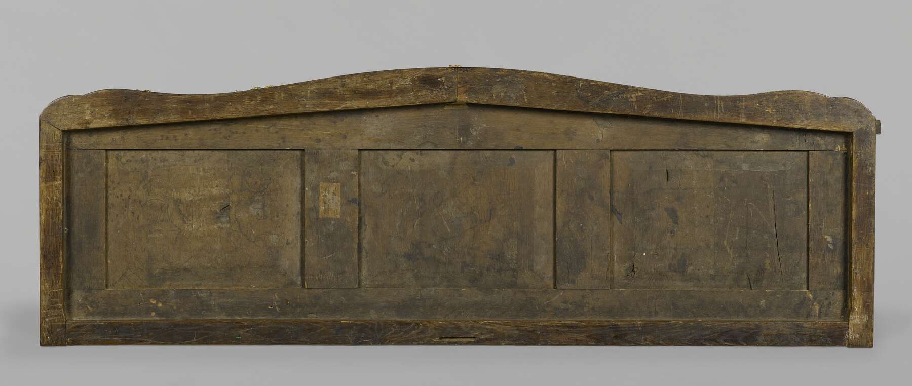 the top of the cabinet from above with the marble removed, showing three inset panels within a framework of structural wood pieces