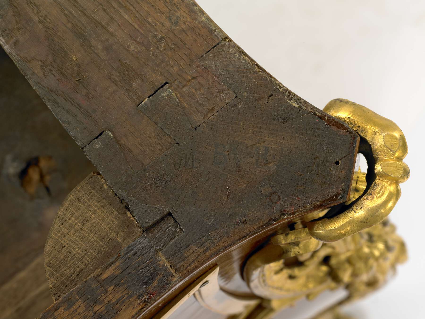 detail of one of the legs showing the dovetail joinery and the faded remnants of imprinted stamps