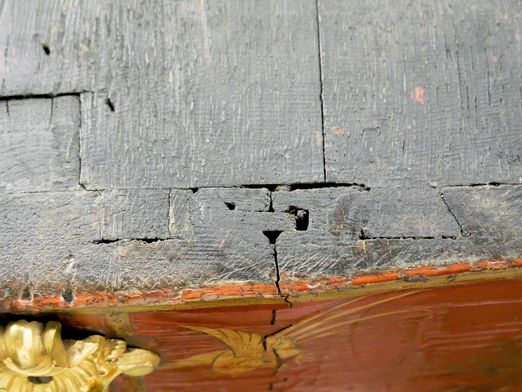 detail of the side panel joinery, highlighting the gaps in the wood around the dovetail joints