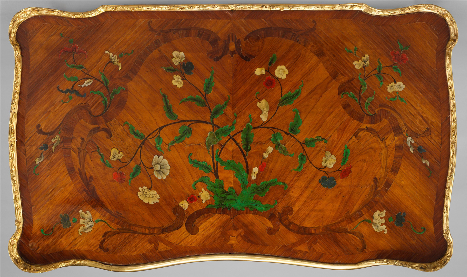 the surface of an additional writing table with floral marquetry in bright shades of green, yellow, white, blue and red
